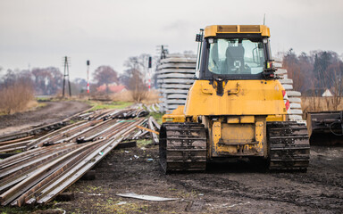 yellow crawler bulldozer taking part in the reconstruction of the railway line