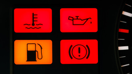four indicator lights on the dashboard of an old car