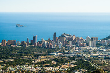 Naklejka na ściany i meble tight, high buildings, apartment buildings, hotels the city of Benidorm. view from the top of the city surrounded by greenery and the sea in the background