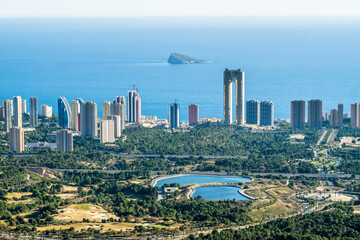 tight, high buildings, apartment buildings, hotels the city of Benidorm. view from the top of the city surrounded by greenery and the sea in the background - obrazy, fototapety, plakaty