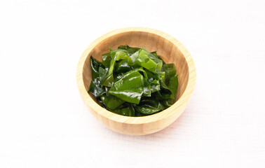 Laminaria (Kelp) seaweed wakame in wooden bowl. Japanese healthy food.