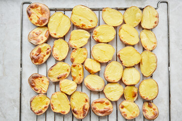 Potato wedges, oven roasted, a close-up in a baking tray. Home cooking. Healthy food, cooked without oil and salt.