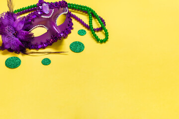 Mardi gras lettering. Congratulation card with violet mask on yellow background Top view 2023 Mardi...
