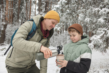 Father and son with a thermal mug and thermos