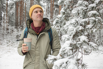 Man in the forest with a thermal mug