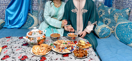 Moroccan family sitting at the breakfast table - obrazy, fototapety, plakaty