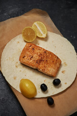 grilled salmon with lemon, pomegranate lying on a flatbread