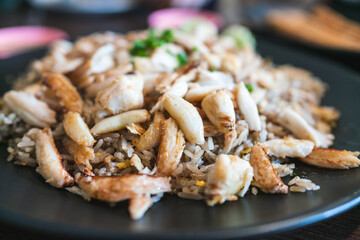 Fried rice with full-loaded fresh chunks of crab, fried with high-temperature Chinese style for a smoked smell. Served with sliced scallion and cucumber. Chinese and Thai style food in Bangkok.