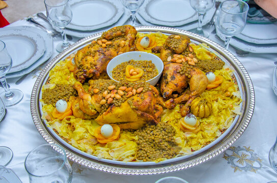 Festive traditional Moroccan Rfissa served with sauce and decorared with quail eggs, seeds, fruit and nuts.