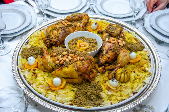 Festive traditional Moroccan Rfissa served with sauce and decorared with quail eggs, seeds, fruit and nuts.