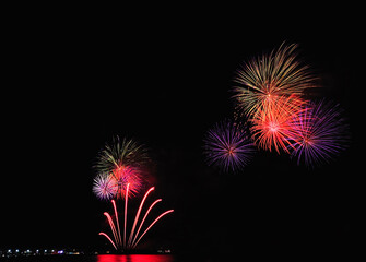  Multicolored fireworks contrast with the black night sky. 