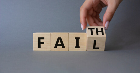 Faith vs Fail symbol. Businessman hand Turnes cube and changes word Fail to Faith. Beautiful grey background. Business and Faith vs Fail concept. Copy space