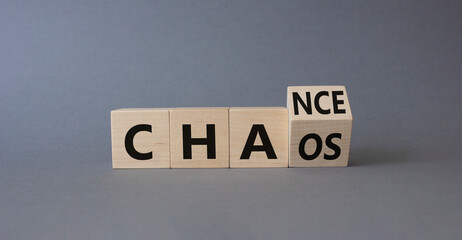 Chance vs Chaos symbol. Turned wooden cubes with words Chaos and Chance. Beautiful grey background. Psychology and Chance vs Chaos concept. Copy space