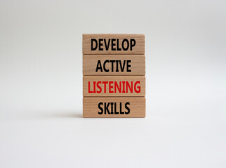 Listening skills symbol. Concept word Develop active listening skills on wooden blocks. Beautiful white background. Business and Develop active listening skills concept. Copy space