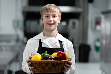 boy student in the kitchen studying cooking