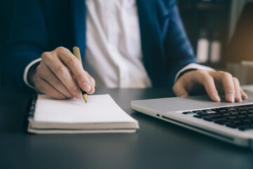 Male hands taking notes on a handwritten notepad, creative writing.