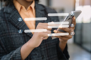 Businesswoman using mobile phone to chat with friends during free time.