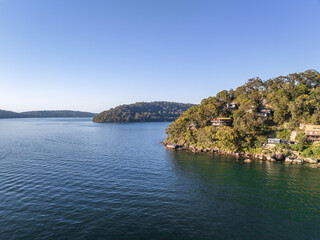 Drone view of holiday homes at Sinclair Point and Soldiers Point (back) near Great Mackerel Beach on the western shores of Pittwater in Ku-ring-gai Chase National Park, Sydney, NSW, Australia.