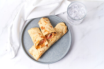Fresh chicken roll with fresh tomatos, salad, wrap