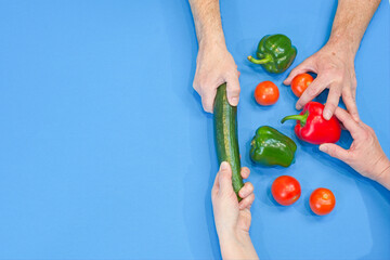 Concept image of the vegetable shortage. Hands grab at a limited pile of vegetables pulling in...