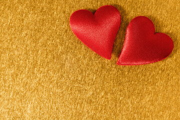 Valentine day background with two red hearts on shiny golden background