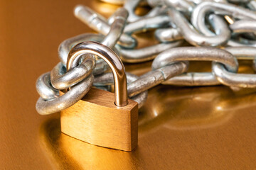 Yellow padlock with a pile of metal chain