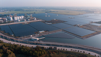 Solar Photovoltaic of solar farm aerial view, solar plant rows array of on the water mount system Installation in earthen pond, Floating solar or floating photovoltaics (FPV). Morning scene,