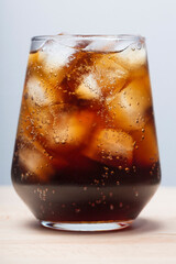 rum with cola and ice in a glass close-up, cola with ice. summer drink