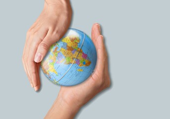Human hands hold earth globe