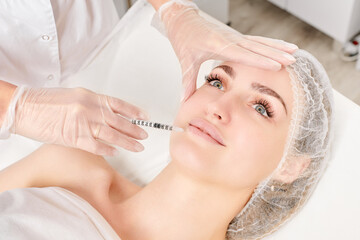 Cosmetologist makes fillers injection for lips augmentation and volume, non surgical cosmetic...