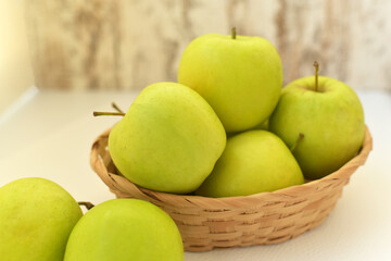 Juicy green apples in a basket