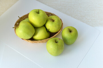 Juicy green apples in a basket