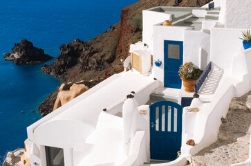 Traditional greek famous white architecture and blue doors on Oia, Santorini island, Greece.