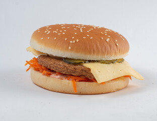 Burger with cutlet, vegetables and cheese in a white sesame bun