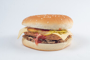 Burger with cutlet, vegetables and cheese in a white sesame bun