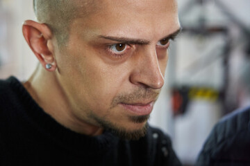 young caucasian man looking closely