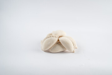 Frozen semi-finished dumplings on a white background