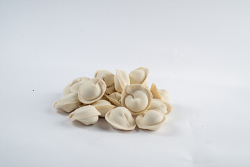 Frozen semi-finished dumplings on a white background