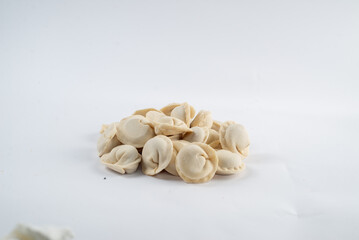 Fototapeta na wymiar Frozen semi-finished dumplings on a white background