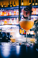 man hand bartender making cocktail in glass on the bar counter
