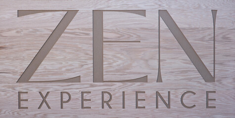 Close-up of a wooden sign with engraved text Zen experience in u spiritual retreat in Mexico