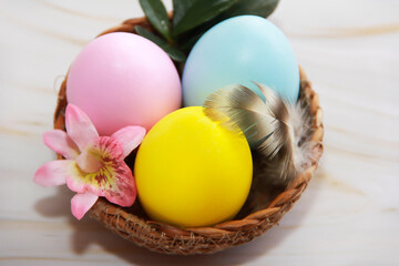Festive multicolored Easter eggs in a decorative brown plate