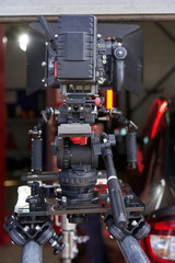 professional movie camera on camera trolley and rails rear view
