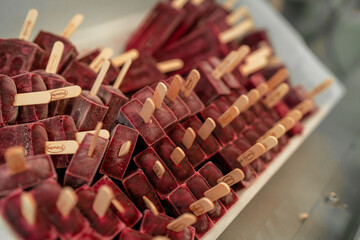 horizontal photo of tasty grape and berries flavored ice cream popsicles