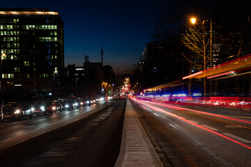 Naklejka premium Saint Josse, Brussels Capital Region, Belgium - Cityscape view over the business district with the light trails of traffic at the central boulevard