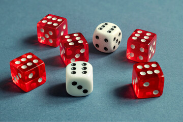 Random number generator. Red and white dice with numerical values lie in a chaotic order.