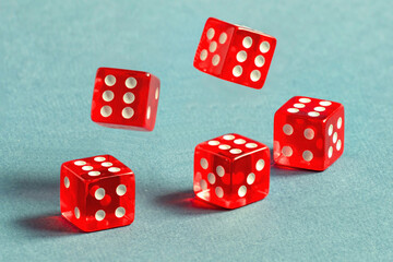 Random number generator. Five red dice with numerical values lie in a chaotic order.