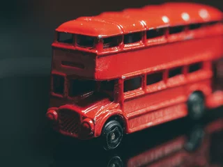 Rolgordijnen Detail with a double decker red bus toy © Cristi