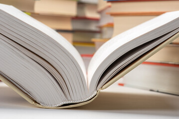 Naklejka premium Opened book in library close-up