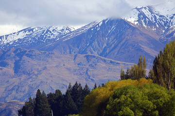 Fototapeta premium The Southern Alps in Central Otago, New Zealand, beautiful snowy mountains with colourful autumn forests. In South Island, New Zealand